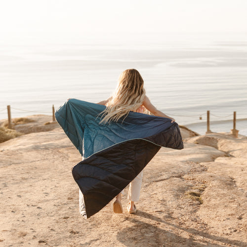 Woman Wrapped In Ocean Fade Blanket Overlooking The Ocean